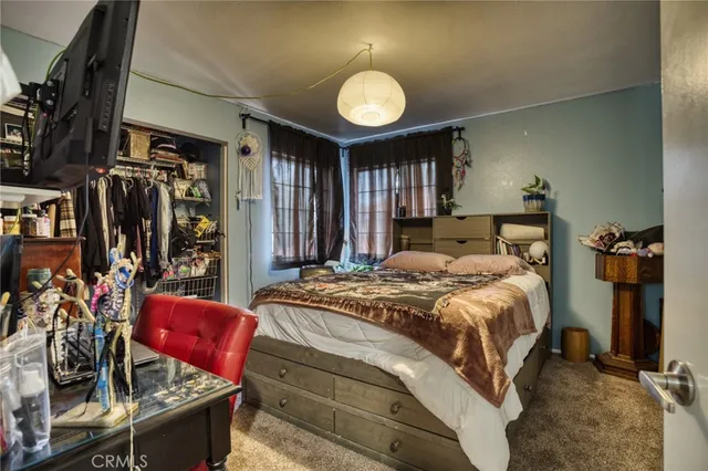 a bedroom with a bed and dresser