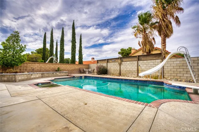 a view of swimming pool with a lounge chairs