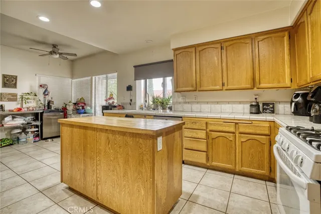 a kitchen with stainless steel appliances granite countertop a sink counter space cabinets and a window