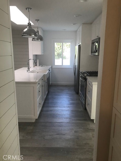 29095 Madrid Road Laguna Niguel, CA 92677 - Photo 8 of 36 a kitchen with sink a refrigerator and wooden floor