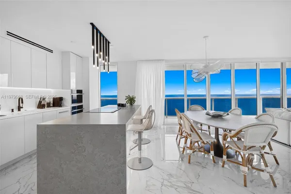 a living room with furniture a flat screen tv and a floor to ceiling window