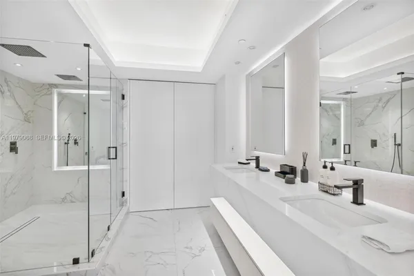 a bathroom with a shower a toilet and sink