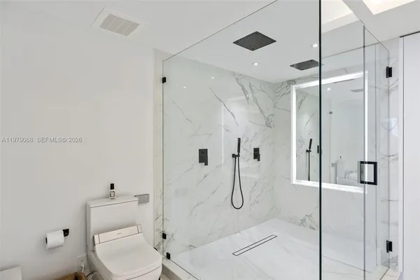 a bathroom with double vanity sinks and a mirror