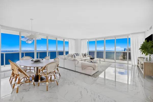 a living room with furniture a rug and white walls