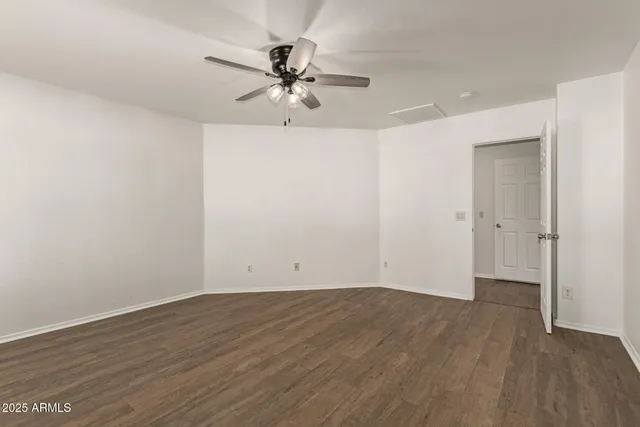 a view of a room with wooden floor and closet area