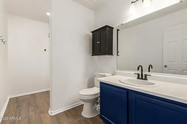 a bathroom with a sink toilet and mirror