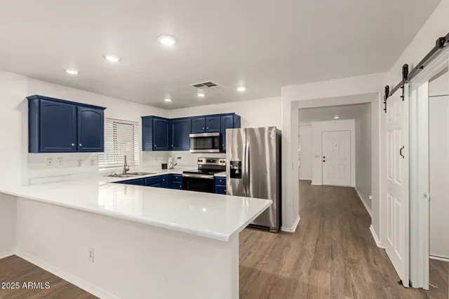a kitchen with stainless steel appliances a refrigerator and a sink