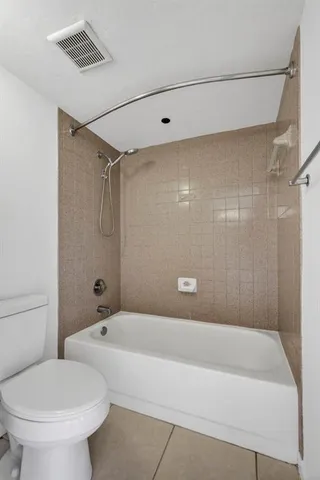 a bathroom with a bathtub and a toilet