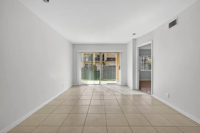a view of an empty room with glass door