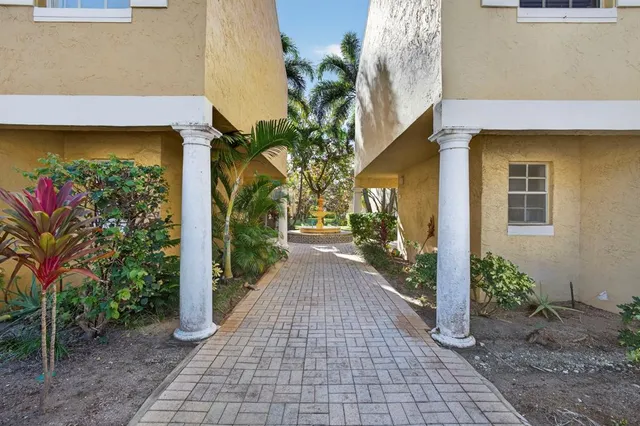 a view of a pathway both side of the house