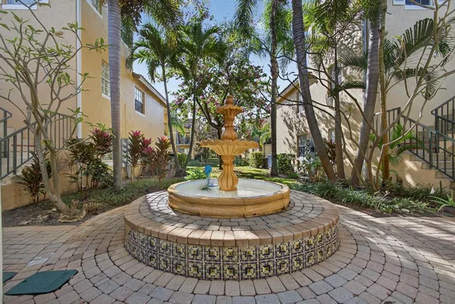 a view of a house with a yard fire pit and tree s