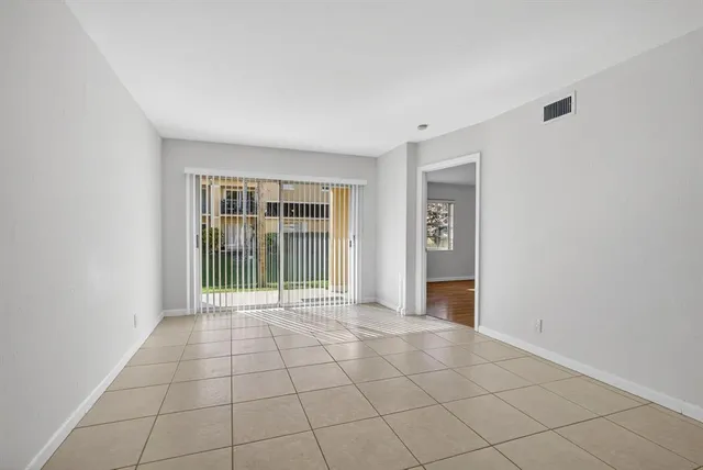 a view of an empty room with glass door