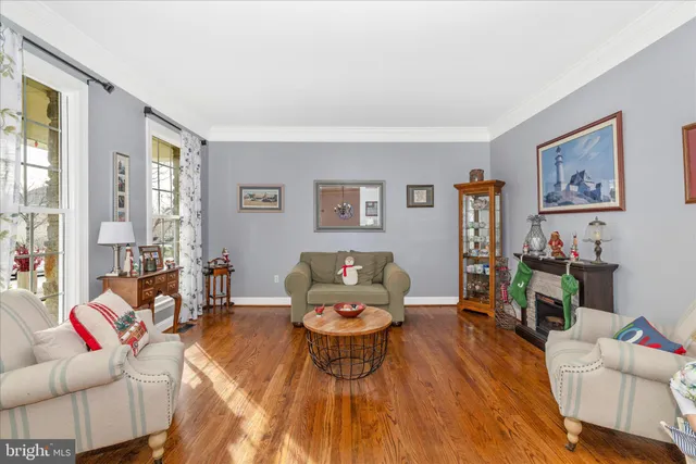 a kitchen with stainless steel appliances granite countertop a refrigerator oven a sink dishwasher and white cabinets with wooden floor