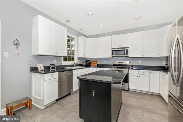 a living room with a large window and a book shelf