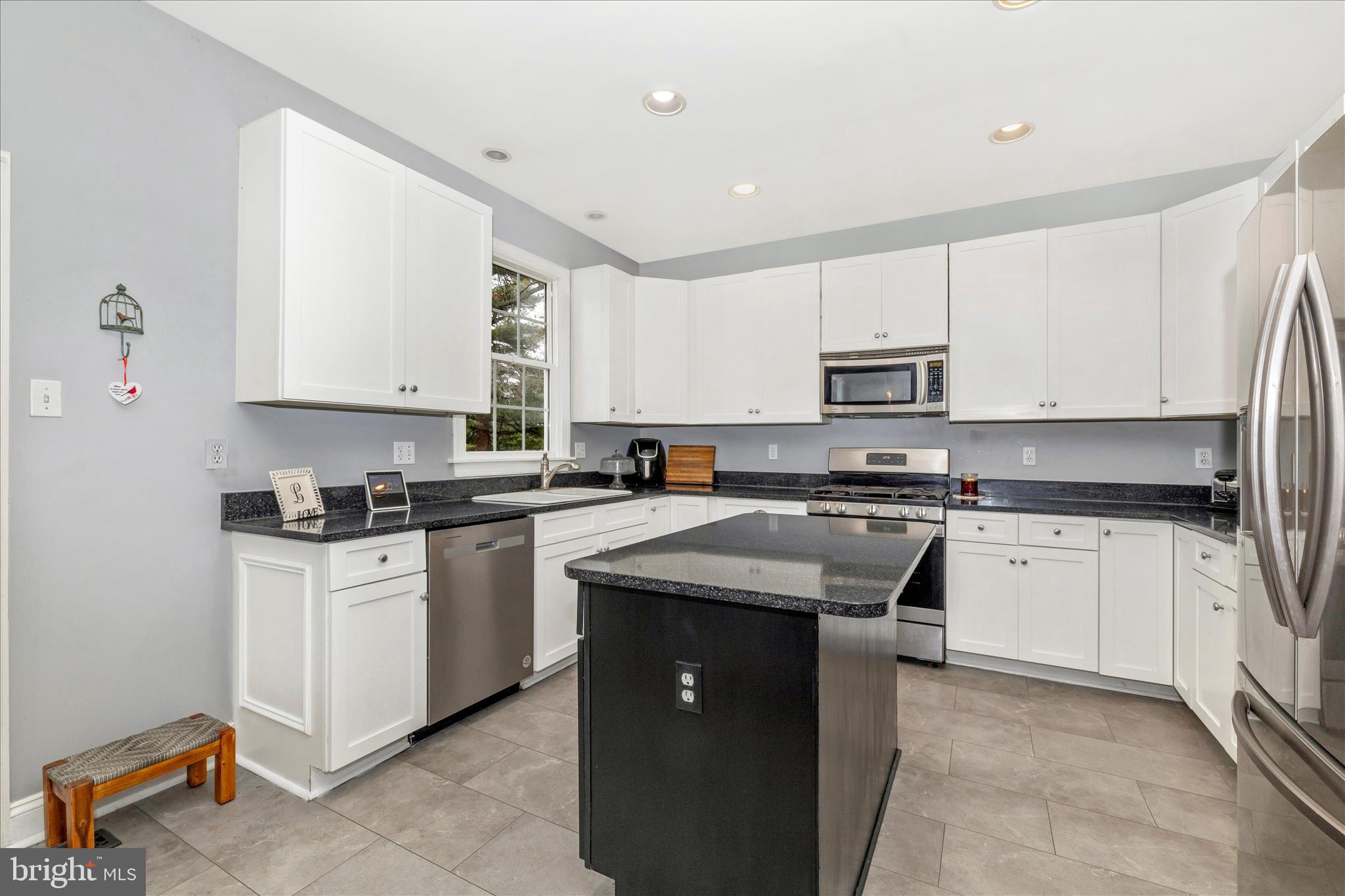 11306 Country Club Road New Market, MD 21774 - Photo 20 of 77 a kitchen with stainless steel appliances granite countertop a stove sink and cabinets