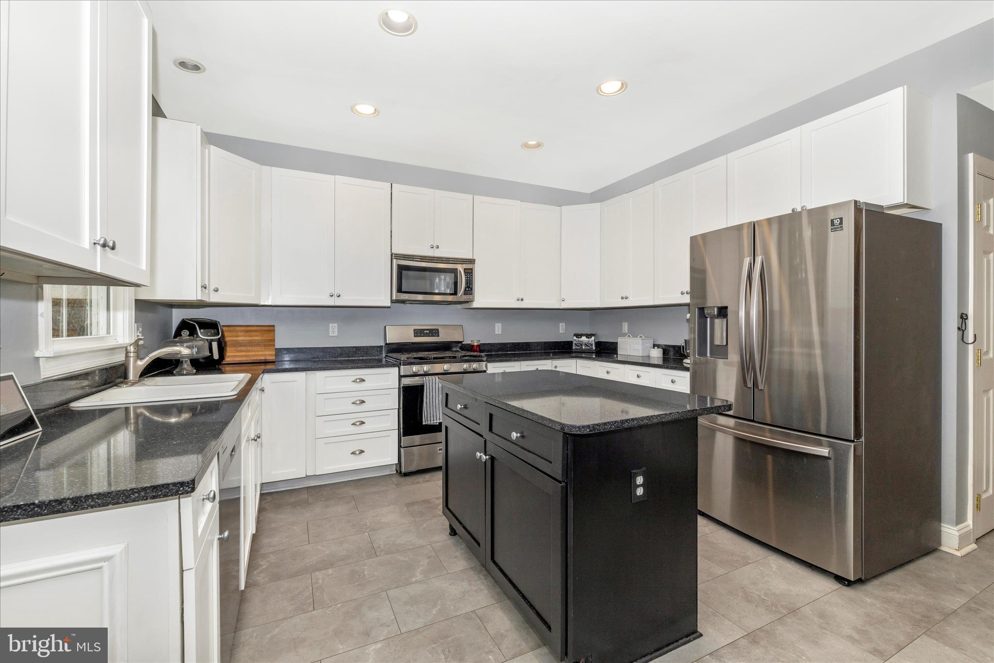 11306 Country Club Road New Market, MD 21774 - Photo 21 of 77 a kitchen with a refrigerator stove and sink