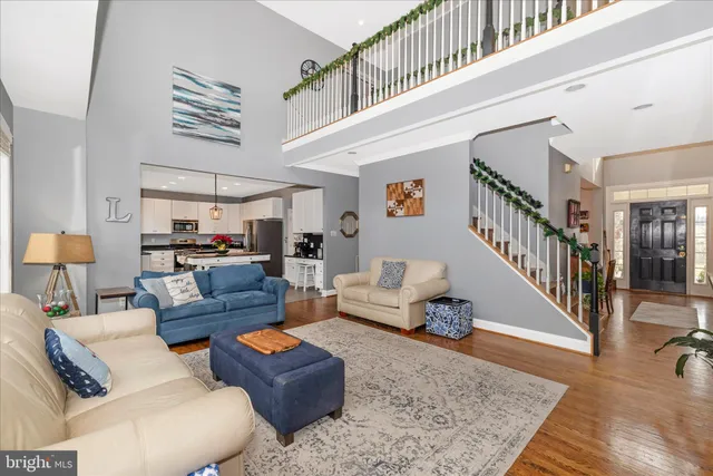 a spacious bedroom with a bed a chandelier and a window