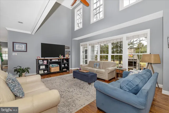 a bedroom with a bed flat screen tv and a couch
