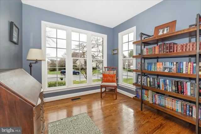a bedroom with a large bed a flat tv screen and dresser