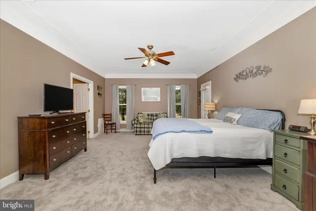 a living room with furniture a flat screen tv and gym equipment