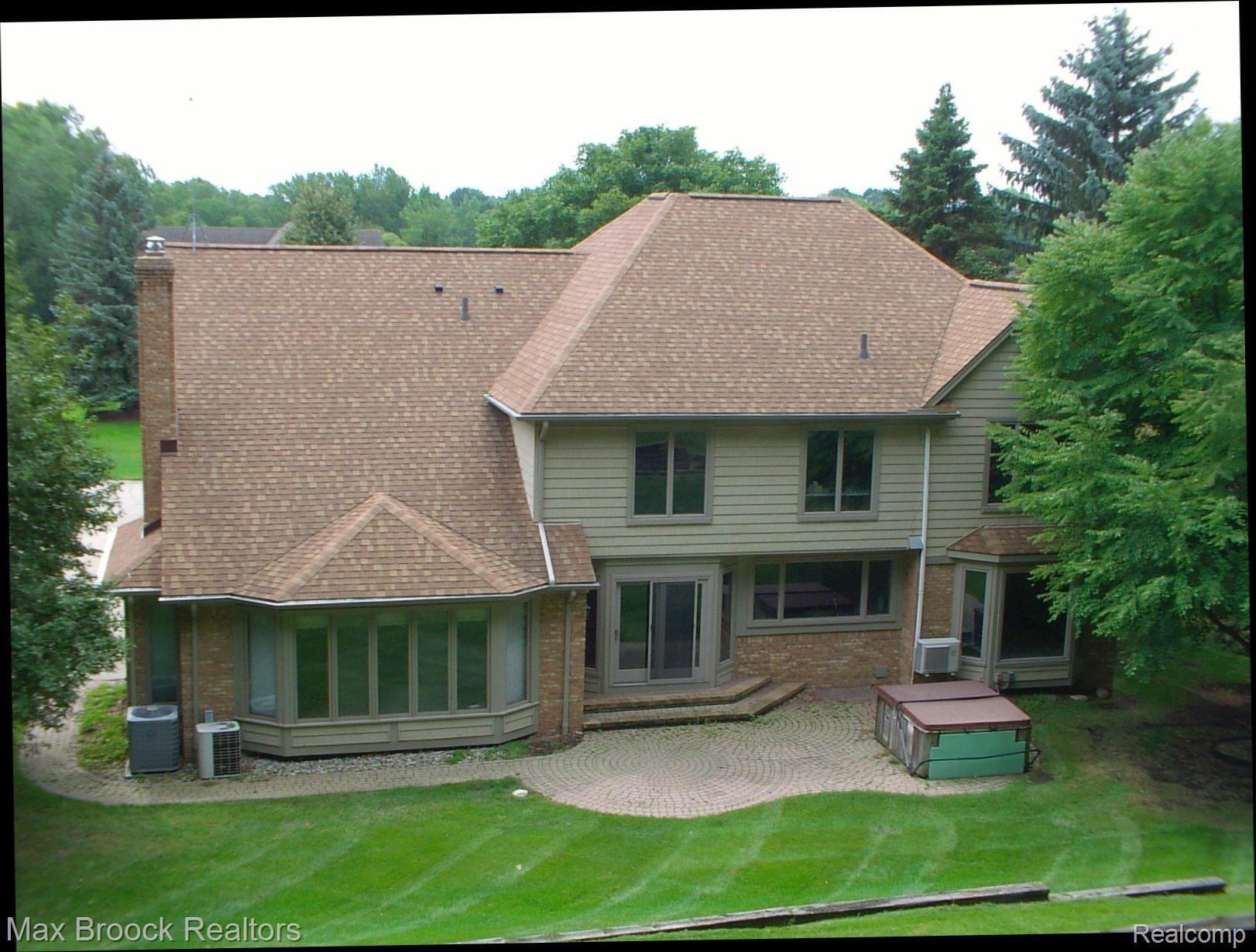 2817 Eagle Drive Rochester, MI 48309 - Photo 3 of 31 Rear of house showing patio, hot tub and dual bay windows