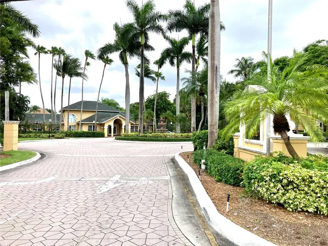 a view of a street with a cars parked on the road