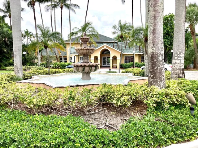 a front view of multiple houses with yard