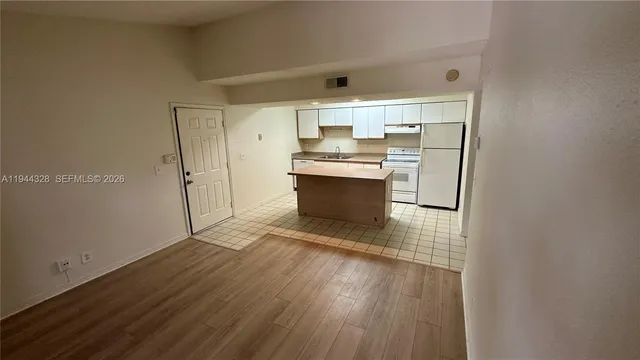 a kitchen with stainless steel appliances a sink and a refrigerator