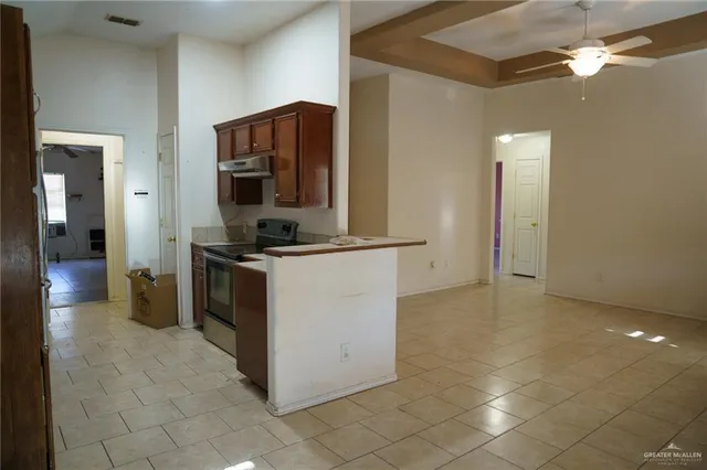 a kitchen with stainless steel appliances granite countertop a sink and a refrigerator