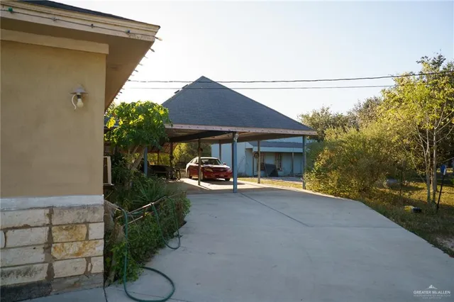 a view of a house with backyard and sitting area