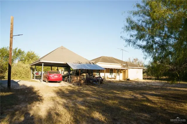 a blue swimming pool is sitting in front of a house