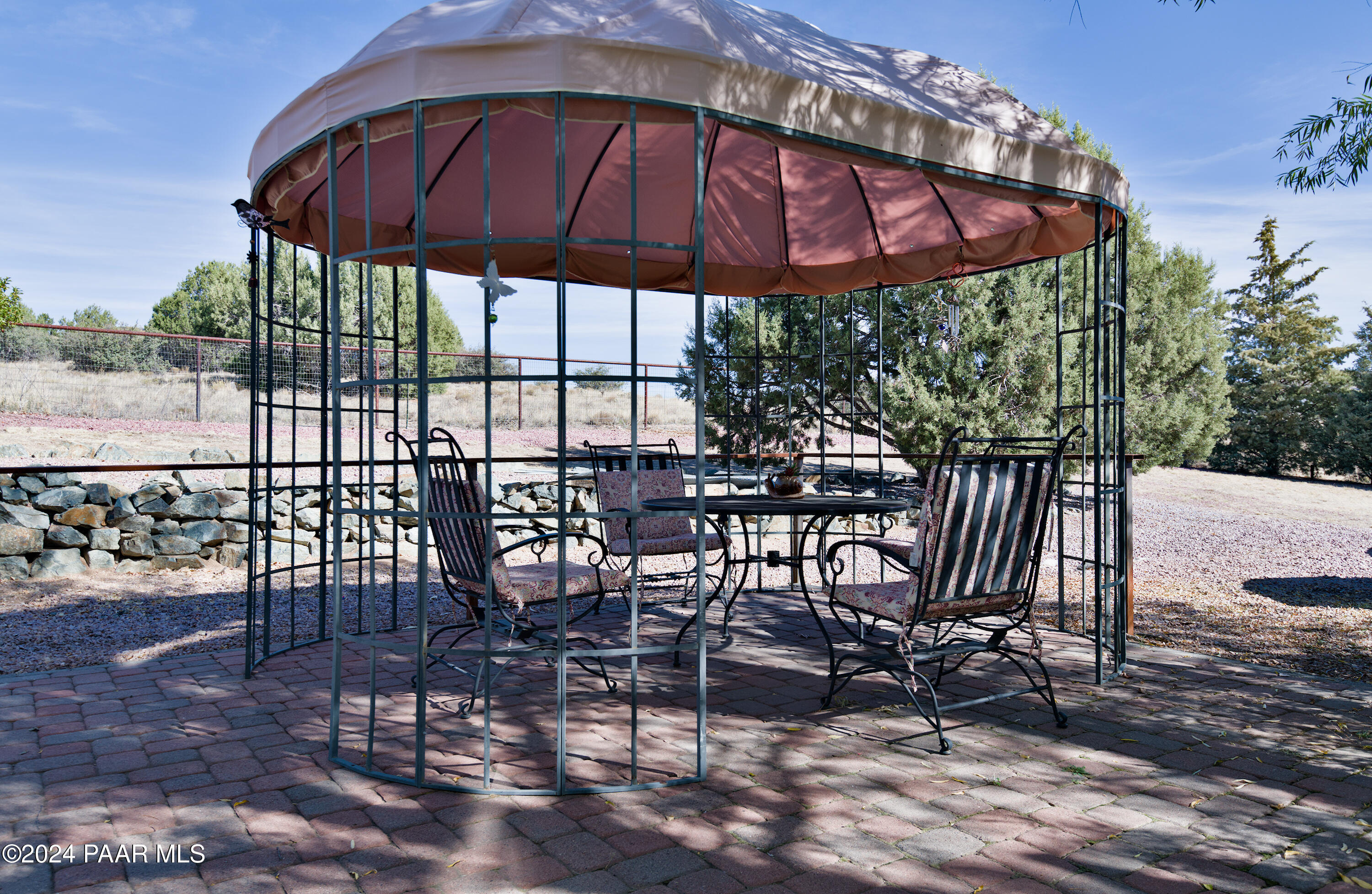 4860 West Stazenski Road Prescott, AZ 86305 - Photo 42 of 67 a view of yard with table and chairs under an umbrella