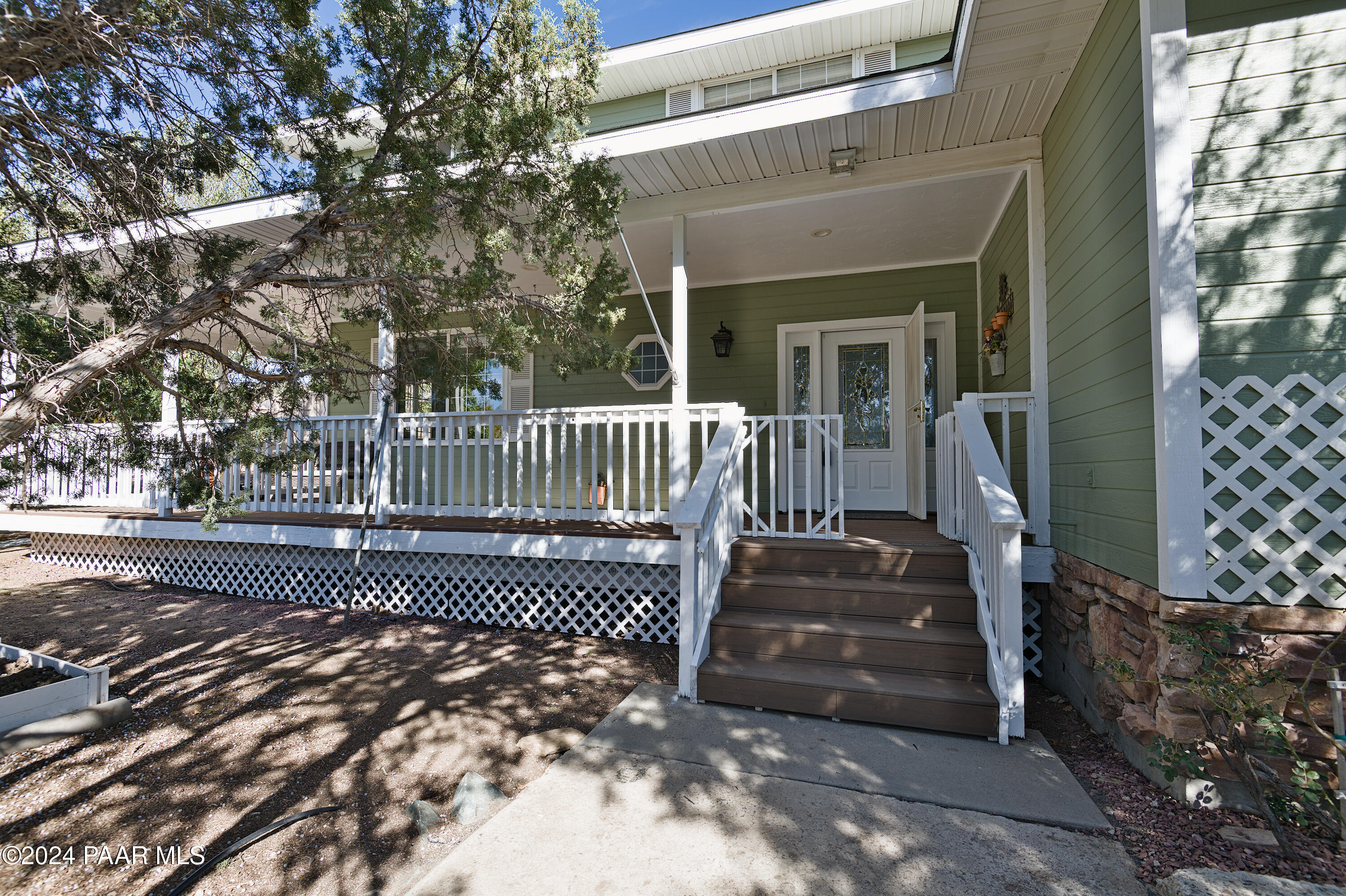 4860 West Stazenski Road Prescott, AZ 86305 - Photo 5 of 67 a view of a brick house with a small yard and wooden fence
