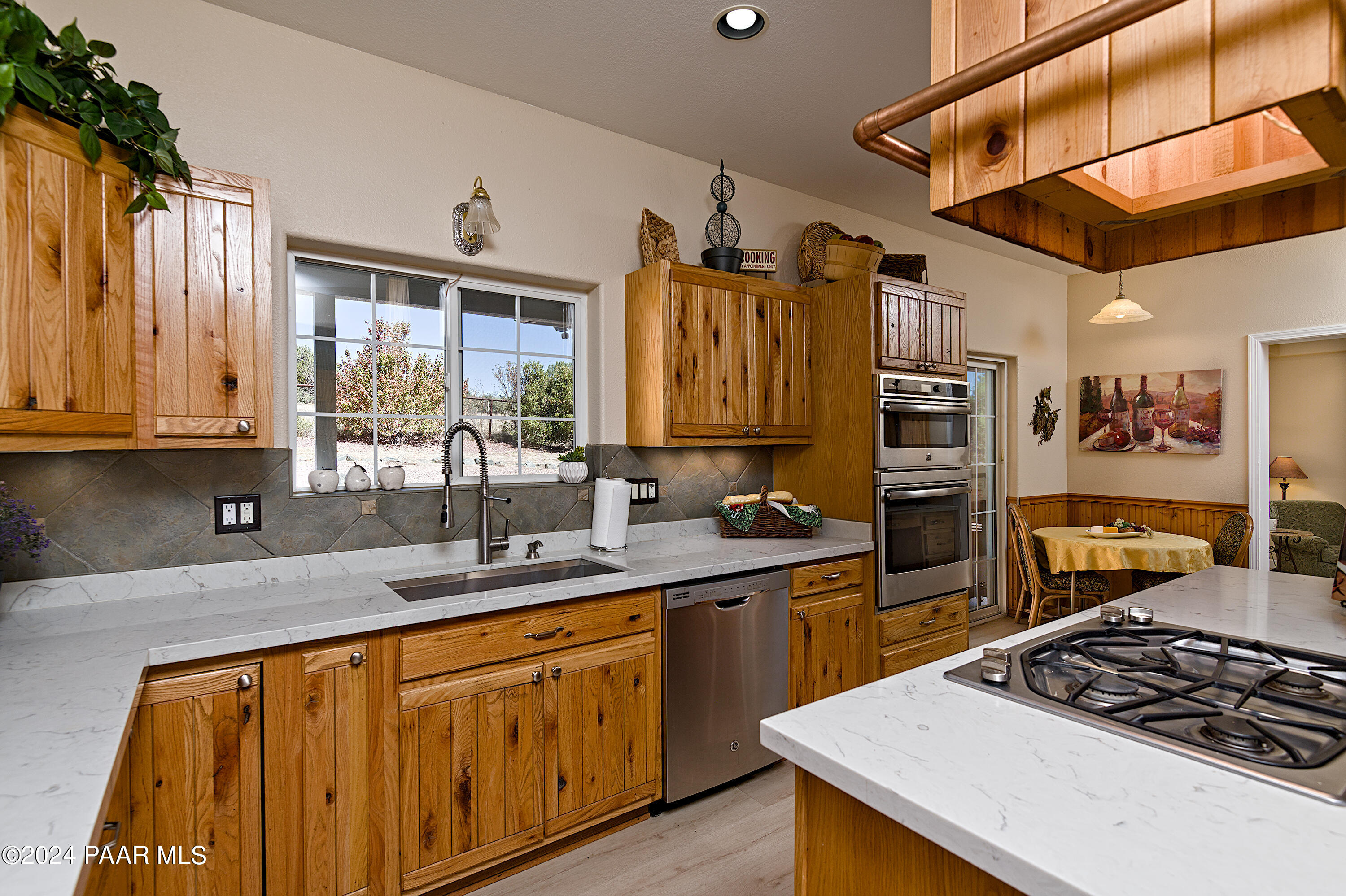 4860 West Stazenski Road Prescott, AZ 86305 - Photo 8 of 67 a kitchen with stainless steel appliances a sink stove and cabinets
