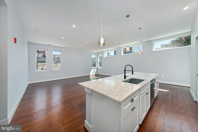 a hallway with sink and mirror