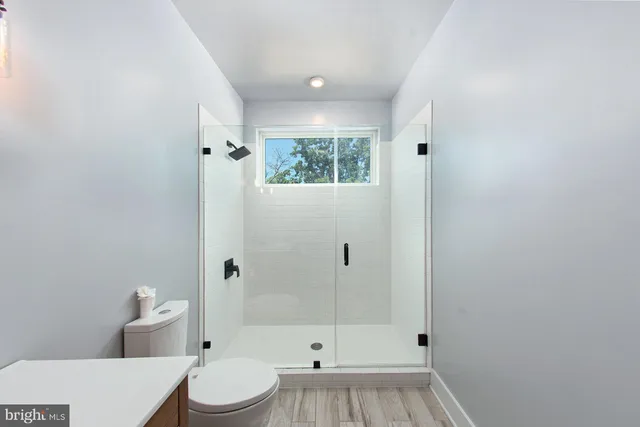 a bathroom with a toilet a sink and shower
