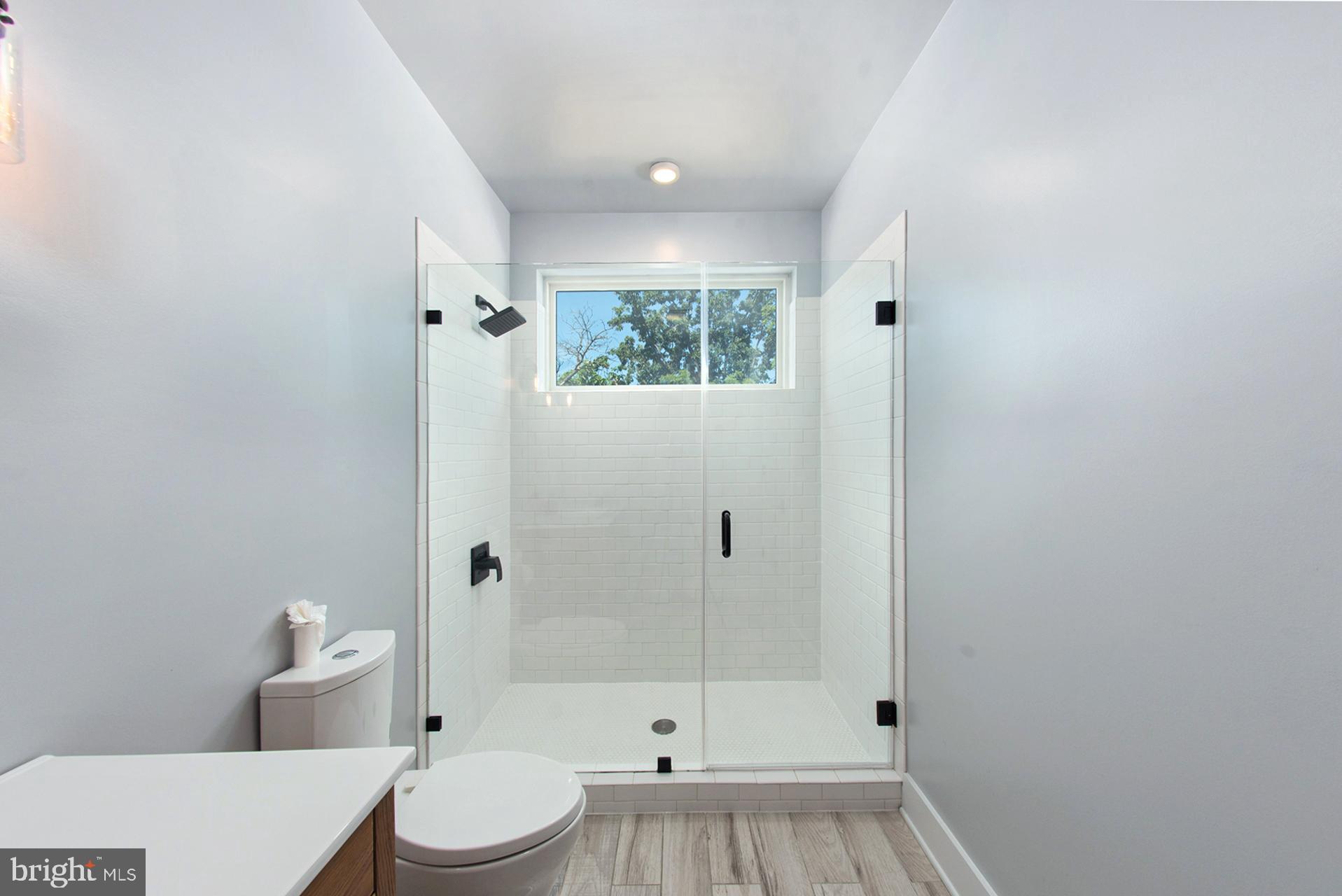 3542 Warder Street Northwest, Unit 204 Washington, DC 20010 - Photo 19 of 29 a bathroom with a toilet a sink and shower