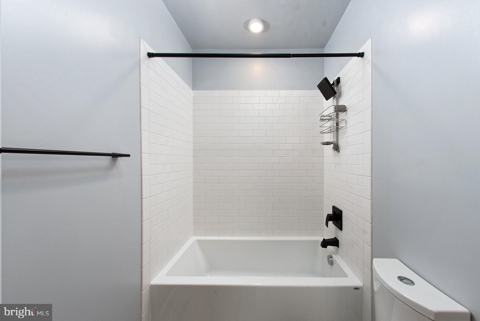 3542 Warder Street Northwest, Unit 204 Washington, DC 20010 - Photo 23 of 29 a bathroom with a bathtub and a shower
