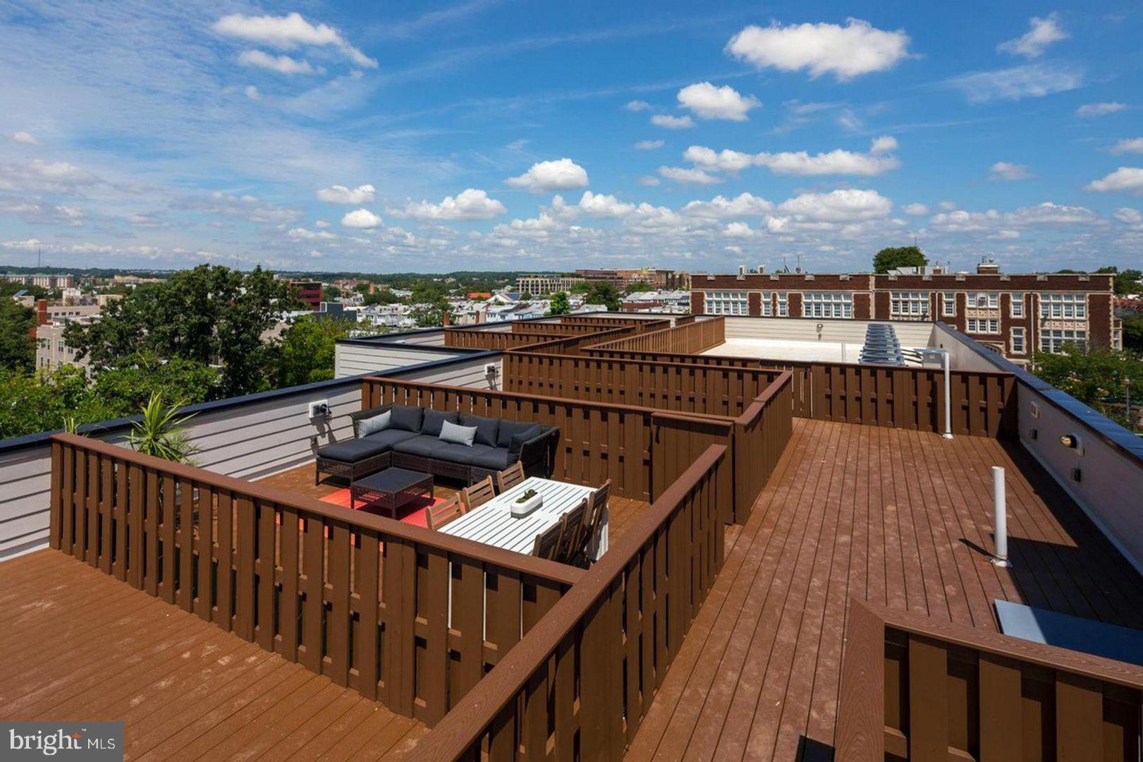 3542 Warder Street Northwest, Unit 204 Washington, DC 20010 - Photo 25 of 29 a balcony with wooden floor and outdoor seating