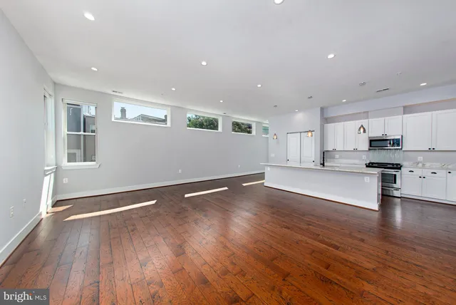 a view of kitchen with cabinets and wooden floor