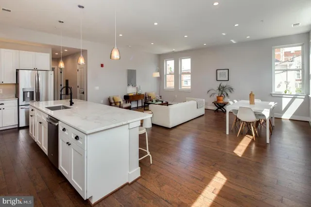 a large kitchen with a table and chairs