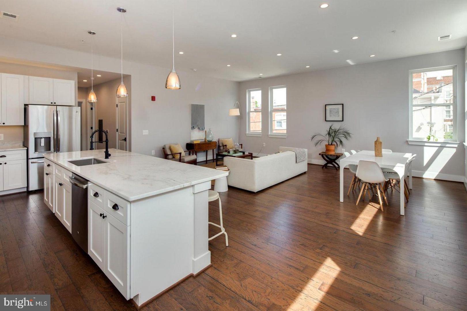 3542 Warder Street Northwest, Unit 204 Washington, DC 20010 - Photo 6 of 29 a large kitchen with a table and chairs