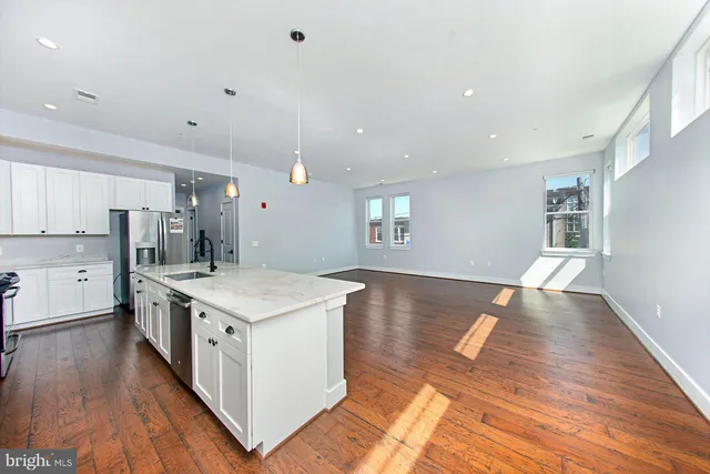 a kitchen with a stove a sink and a refrigerator