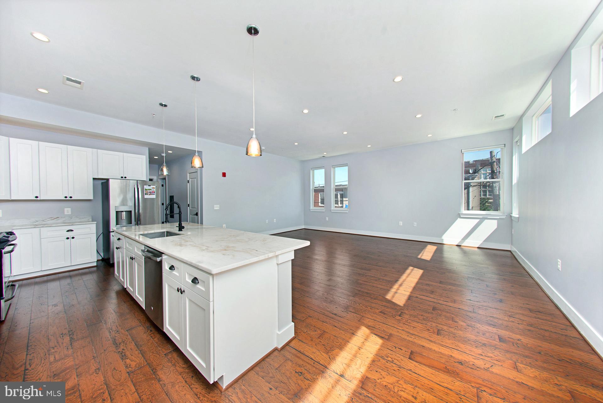3542 Warder Street Northwest, Unit 204 Washington, DC 20010 - Photo 7 of 29 a kitchen with a stove a sink and a refrigerator