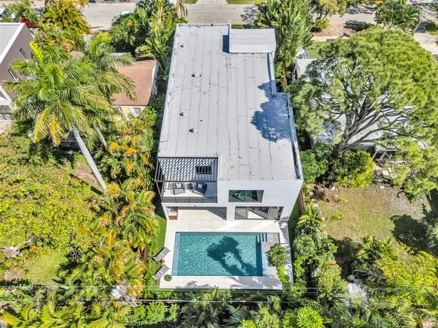 a kitchen with stainless steel appliances kitchen island granite countertop a sink a stove and a refrigerator