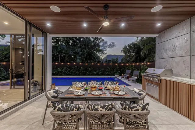 a dining room with furniture a large window and a table
