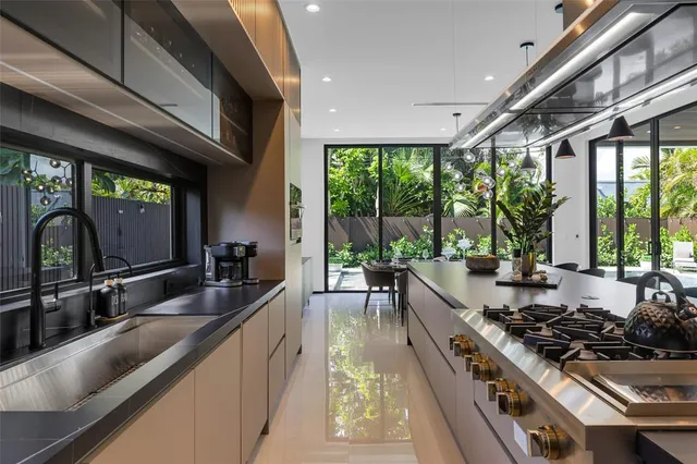 a bathroom with a granite countertop sink a toilet a mirror and shower