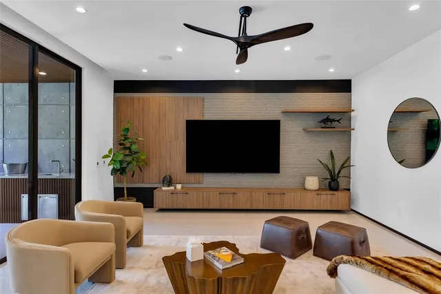 a spacious bedroom with a large bed and a flat tv screen on dresser