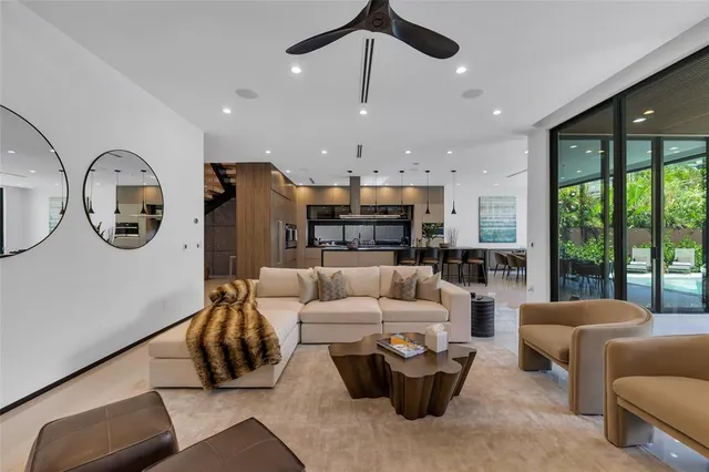 a spacious bedroom with a bed a chandelier and large window