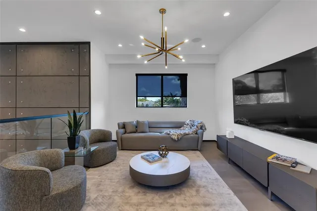 a bedroom with two beds and a flat screen tv